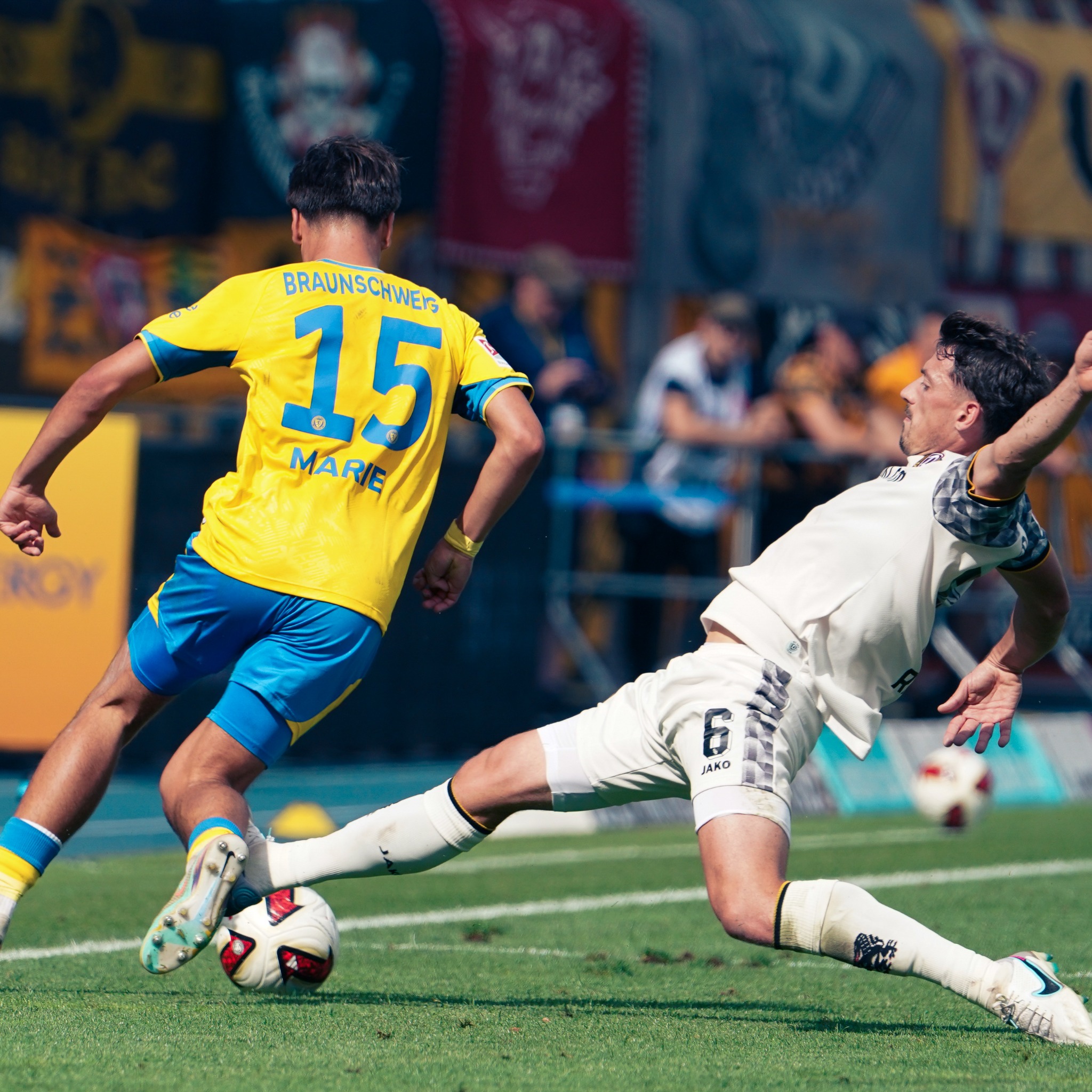 A sliding challenge during Eintracht Braunschweig against Dynamo Dresden at the Eintracht-Stadion.