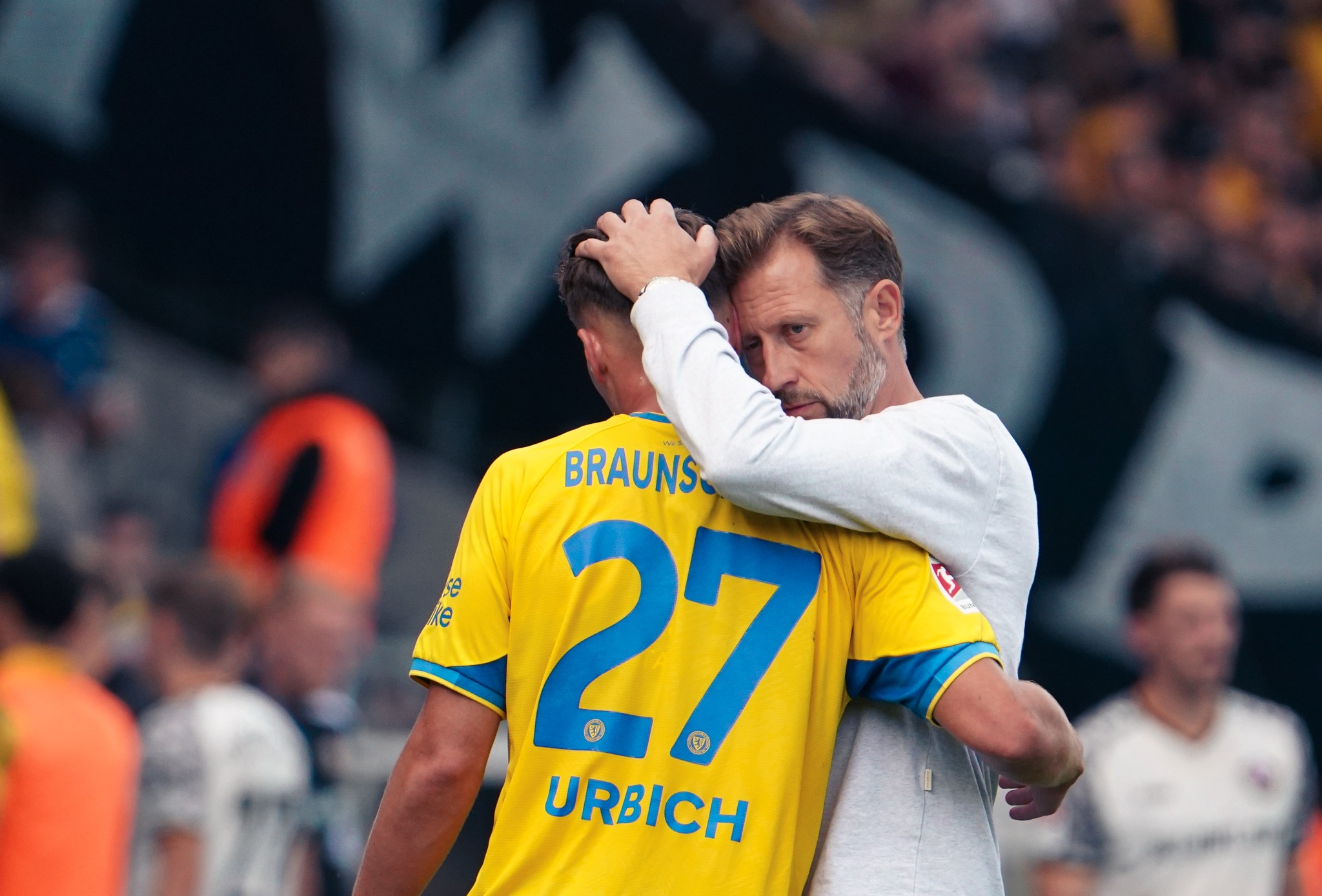 Eintracht Braunschweig player Jan Urbich receives instructions at the touchline during the match against Dynamo Dresden.