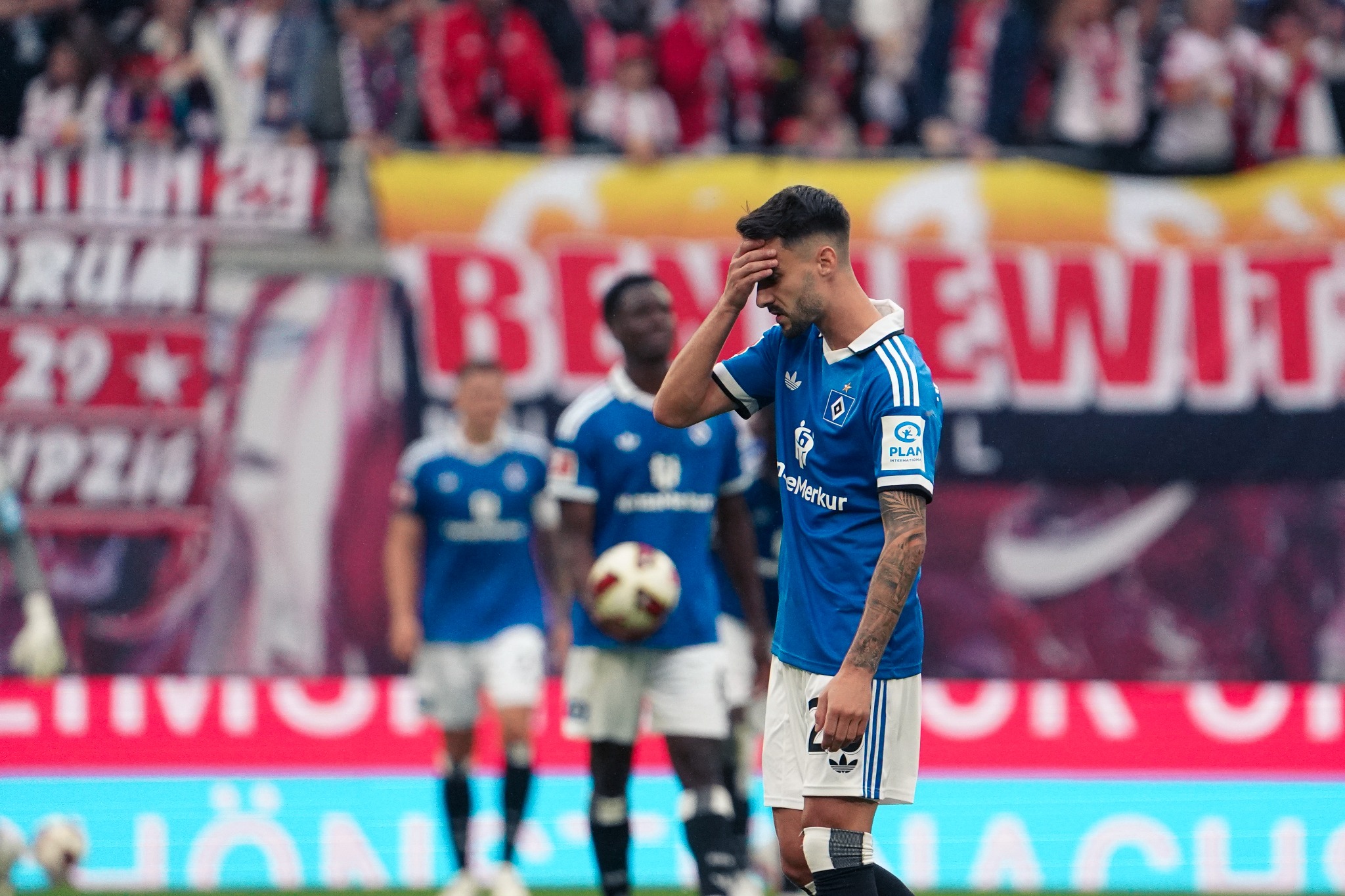 A Hamburger SV player shows disappointment during the 5:0 defeat against RB Leipzig at the Red Bull Arena.